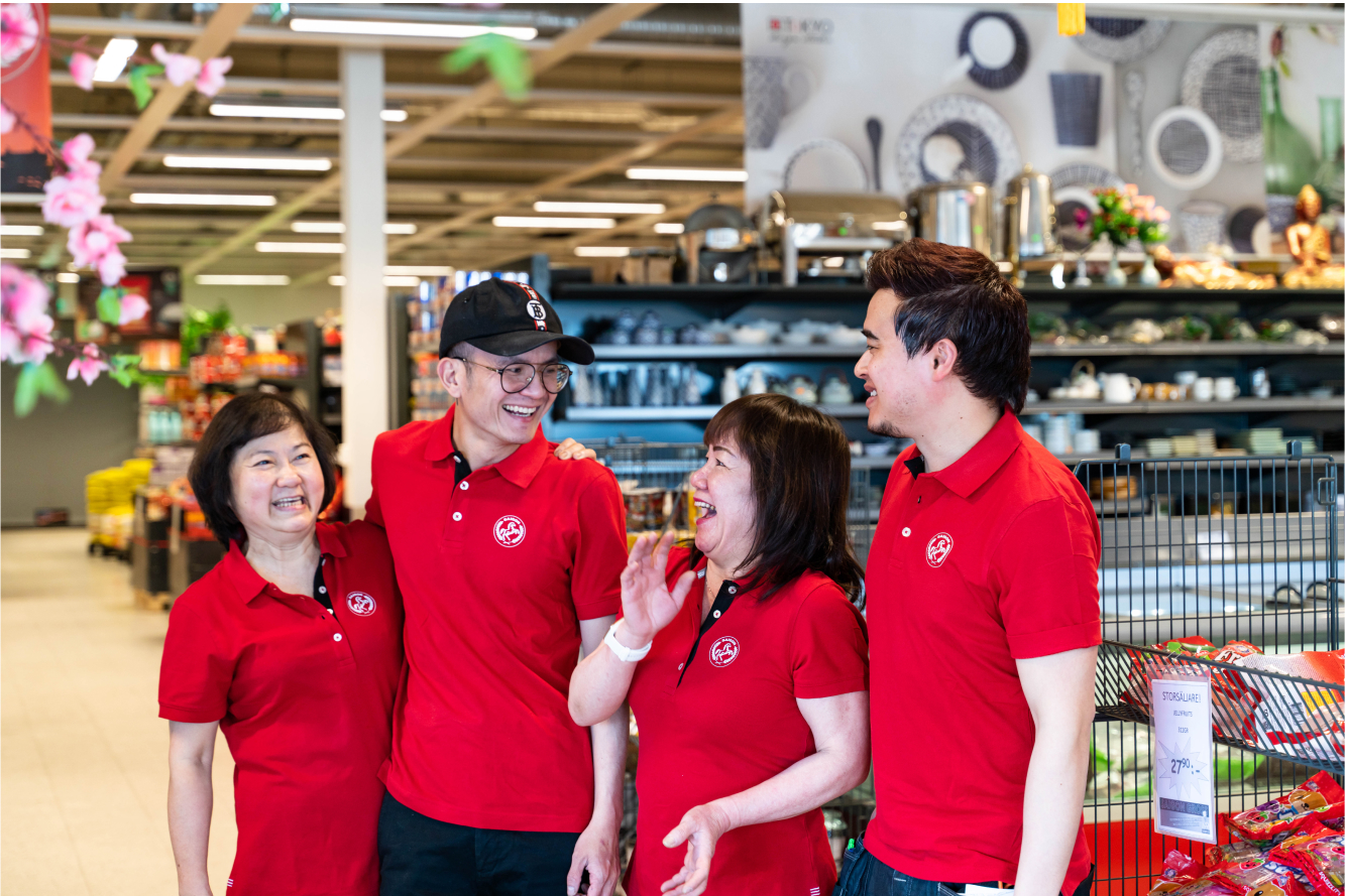 four Saigon food employees laughing, looking at eachother